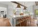 Spacious kitchen with a large marble island, wooden beams, and modern appliances at 1141 Ragley Hall Ne Rd, Brookhaven, GA 30319