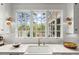 Bright white kitchen featuring a window overlooking a lake, sink and decor at 1141 Ragley Hall Ne Rd, Brookhaven, GA 30319