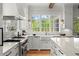 Well-equipped kitchen with white cabinets, marble countertops, and stainless steel appliances at 1141 Ragley Hall Ne Rd, Brookhaven, GA 30319