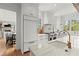 Bright kitchen featuring white cabinets, marble countertops, and modern appliances at 1141 Ragley Hall Ne Rd, Brookhaven, GA 30319