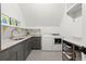 Well-equipped laundry room with gray cabinetry and patterned tile flooring at 1141 Ragley Hall Ne Rd, Brookhaven, GA 30319