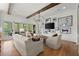 Comfortable living room featuring wood floors, beamed ceilings, and wall art at 1141 Ragley Hall Ne Rd, Brookhaven, GA 30319