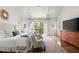 The bedroom boasts a vaulted ceiling, hardwood floors, and access to a private balcony at 1141 Ragley Hall Ne Rd, Brookhaven, GA 30319