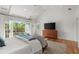 The bedroom boasts a vaulted ceiling, hardwood floors, and access to a private balcony at 1141 Ragley Hall Ne Rd, Brookhaven, GA 30319