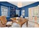 Stylish office with custom built-ins, hardwood floors, and beautiful blue walls at 1141 Ragley Hall Ne Rd, Brookhaven, GA 30319