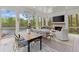 Inviting screened-in porch featuring a dining table, lounge area, and lake views at 1141 Ragley Hall Ne Rd, Brookhaven, GA 30319