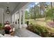 Spacious porch with white columns, comfortable seating, and views of the landscaped yard at 1141 Ragley Hall Ne Rd, Brookhaven, GA 30319