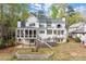 Rear exterior showcasing multiple levels, screened porch, and a stone retaining wall at 1141 Ragley Hall Ne Rd, Brookhaven, GA 30319