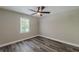 Empty bedroom with wood-look floors, fresh paint, and natural light from a window at 1050 N Carter Rd, Decatur, GA 30030
