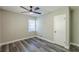 Bedroom with neutral paint, hardwood flooring, ceiling fan, window, and white door at 1050 N Carter Rd, Decatur, GA 30030