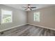 A well-lit bedroom features wood-look floors, fresh paint, and natural light from two windows at 1050 N Carter Rd, Decatur, GA 30030