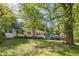 Charming one-story home with white siding, black shutters, and mature landscaping at 1050 N Carter Rd, Decatur, GA 30030