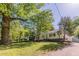 Charming one-story home with white siding, black shutters, and mature landscaping at 1050 N Carter Rd, Decatur, GA 30030