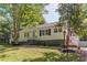Charming one-story home with white siding, black shutters, and mature landscaping at 1050 N Carter Rd, Decatur, GA 30030