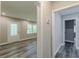 Hallway leading to a living room with grey laminate flooring and a white front door at 1050 N Carter Rd, Decatur, GA 30030