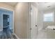 Hallway leading to a newly renovated bathroom featuring white marble tiling at 1050 N Carter Rd, Decatur, GA 30030