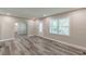 Bright living room with hardwood floors, arched doorway, and large windows for plenty of natural light at 1050 N Carter Rd, Decatur, GA 30030