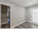 A light-filled room with grey laminate flooring and a view of the backyard at 1050 N Carter Rd, Decatur, GA 30030