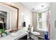 Neutral bathroom with a single sink, framed mirror, and natural light from a window at 164 Chickasaw Ln, Austell, GA 30168