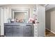 Bedroom featuring modern grey dresser with adjacent door and accent mirror at 164 Chickasaw Ln, Austell, GA 30168