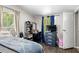 Cozy bedroom with natural light, laminate flooring, closet, and dresser storage at 164 Chickasaw Ln, Austell, GA 30168