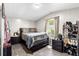 Bedroom featuring updated bed, side table, and large shoe rack for ample storage at 164 Chickasaw Ln, Austell, GA 30168