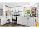 Bright kitchen featuring white cabinets, stainless steel appliances, and a window overlooking greenery at 164 Chickasaw Ln, Austell, GA 30168