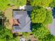 Overhead shot of a brick home with a well-manicured yard and patio seating area at 225 Wexford Overlook Dr, Roswell, GA 30075