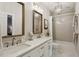 Stylish bathroom with dual sinks, framed mirrors, modern lighting, and tiled shower, offering a luxurious and functional design at 225 Wexford Overlook Dr, Roswell, GA 30075