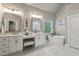 Bright bathroom features double vanities, a makeup area, a soaking tub, and a window with natural light at 225 Wexford Overlook Dr, Roswell, GA 30075