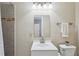 Bright bathroom featuring a vanity with sink, tiled shower, and a well-lit mirror, creating a clean and functional space at 225 Wexford Overlook Dr, Roswell, GA 30075
