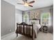 Cozy bedroom with a decorative bed frame, bedside table, and a window with natural light at 225 Wexford Overlook Dr, Roswell, GA 30075
