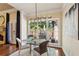 Bright breakfast nook with a glass table, four chairs, and a view of the outdoor patio at 225 Wexford Overlook Dr, Roswell, GA 30075