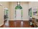 Open foyer with high ceilings, hardwood floors, and natural light from a front door transom at 225 Wexford Overlook Dr, Roswell, GA 30075
