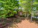Charming single-story brick home with a landscaped front yard and mature trees at 225 Wexford Overlook Dr, Roswell, GA 30075