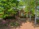 Beautiful brick home with mature landscaping, arched windows, and a manicured lawn at 225 Wexford Overlook Dr, Roswell, GA 30075