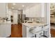 Modern kitchen with white cabinets, stainless steel appliances, and a breakfast bar at 225 Wexford Overlook Dr, Roswell, GA 30075
