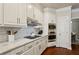 Modern kitchen features white cabinets, marble countertops, stainless steel appliances, and a gas cooktop at 225 Wexford Overlook Dr, Roswell, GA 30075