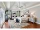 Spacious main bedroom with a tray ceiling, sitting area, hardwood floors, and lots of natural light at 225 Wexford Overlook Dr, Roswell, GA 30075