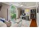 Well-lit office space featuring a built-in desk, shelving, and large windows overlooking the yard at 225 Wexford Overlook Dr, Roswell, GA 30075
