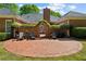 Picturesque brick patio with outdoor seating, lush greenery, and privacy elements, creating a tranquil and inviting space at 225 Wexford Overlook Dr, Roswell, GA 30075