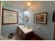 Comfortable bathroom features a vanity with sink, decorative mirror and small framed photos at 2932 Highway 20 Se, Conyers, GA 30013