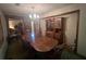 Traditional dining room with table, china cabinet, green carpet and decorative chandelier at 2932 Highway 20 Se, Conyers, GA 30013