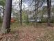 Charming home nestled among trees with a pop of red color among the trees at 2932 Highway 20 Se, Conyers, GA 30013