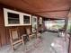 Cozy front porch features rocking chairs, natural light, and a welcoming entrance at 2932 Highway 20 Se, Conyers, GA 30013
