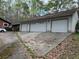 Three-car garage with a long driveway and ample space for parking or storage at 2932 Highway 20 Se, Conyers, GA 30013