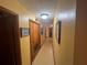 Narrow hallway with closet storage and wall decor, providing access to different areas of the house at 2932 Highway 20 Se, Conyers, GA 30013
