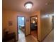 Bright hallway offers access to a bathroom with vanity and a bedroom with traditional furnishings at 2932 Highway 20 Se, Conyers, GA 30013