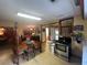Open-concept kitchen with stainless steel appliances, wooden dining table and an adjacent living area at 2932 Highway 20 Se, Conyers, GA 30013