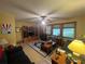 Bright living room with ceiling fan, plush seating, and windows with blinds at 2932 Highway 20 Se, Conyers, GA 30013